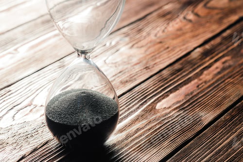 Preview: Modern hourglass on wooden background. Close up