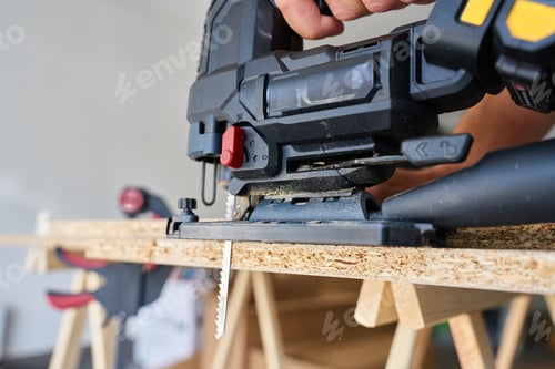Preview: Close-Up of Electric Jigsaw Cutting Wood Panel