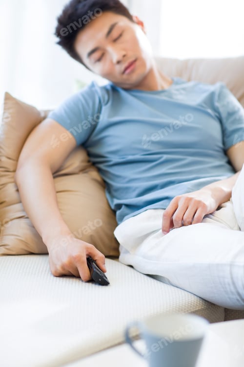 Preview: Young man sleeping on the sofa