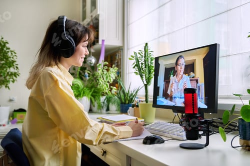 Preview: Teenage female student studying online at home