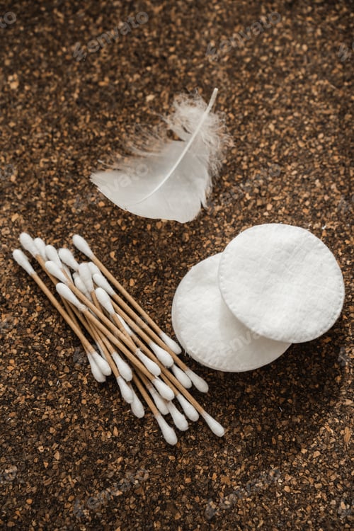 Preview: Cotton Pads and Wooden Cotton Swabs on Cork Surface