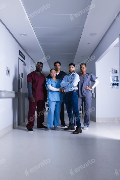 Preview: Portrait of diverse male and female doctors standing in hospital corridor