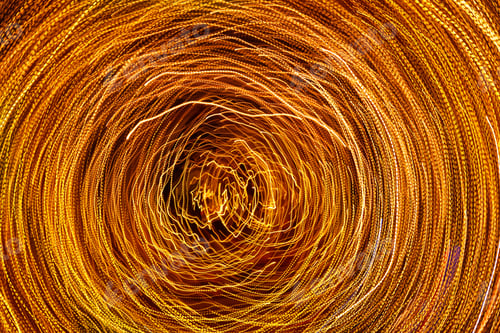 Preview: Long exposure photography, orbiting lines of vibrant metallic yellow gold