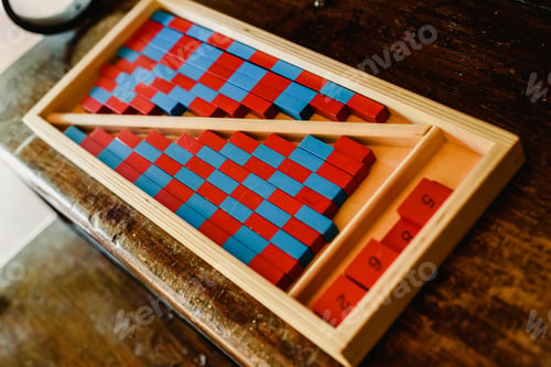 Preview: Game to learn to count, made of blue and red wood, inside a classroom montessori.