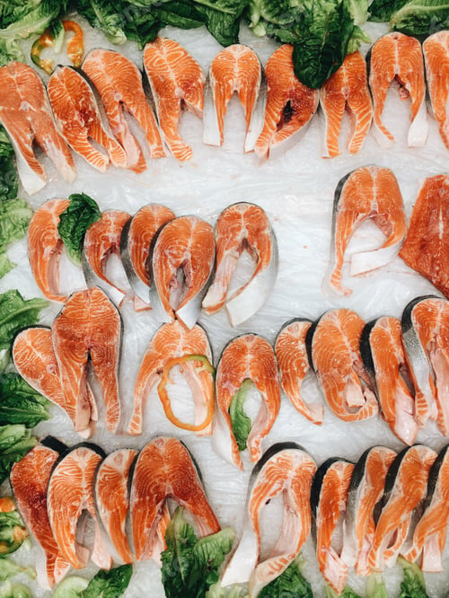 Preview: Fresh Salmon Steaks Displayed With Green Vegetables