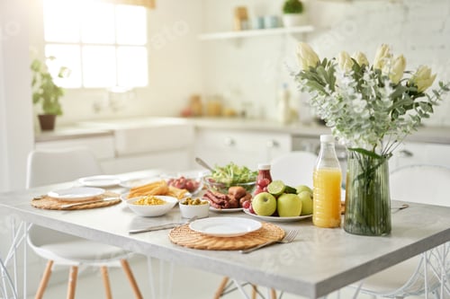 Preview: Design ideas. Close up of vase with flowers and Latin style breakfast on the kitchen table. Modern