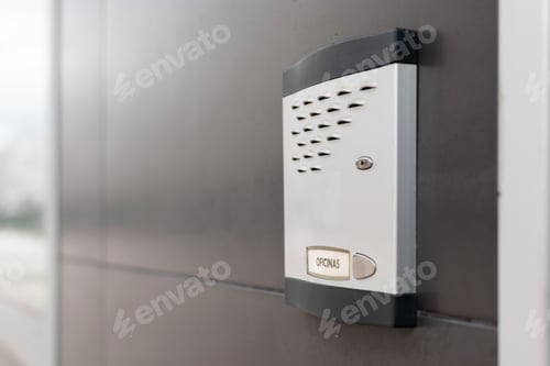 Preview: View of an office building intercom on a gray wall with a blurred background