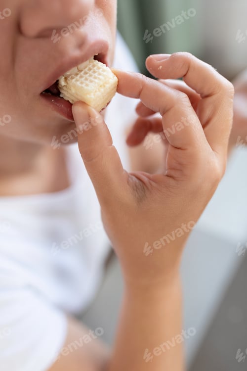 Preview: a woman stuffs a waffle cake into her mouth. concept of weight gain and diet failure