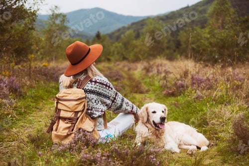 Woman and Dog Resting in Mountain Meadow