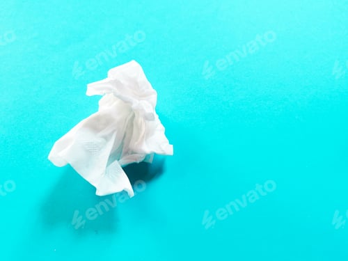 Preview: Image of used white tissue paper against blue background.