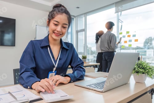 Preview: Close up Business woman using calculator and laptop for do math finance on wooden desk in office and
