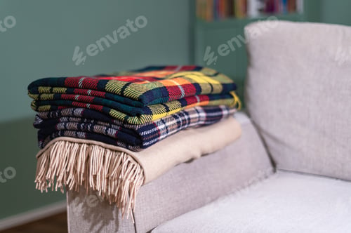 Preview: Stack of woolen checked blankets