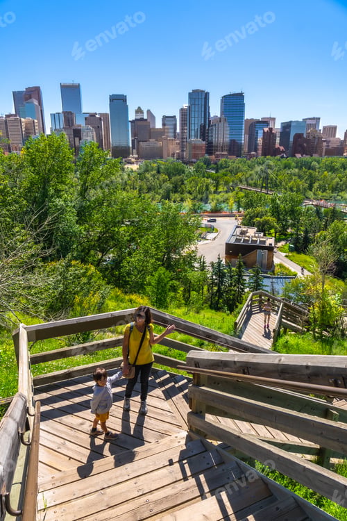 Preview: Mother and son walking down wooden stairs in calgary city park