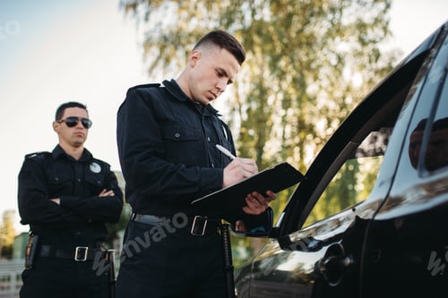 Preview: Male police officers check vehicle on the road