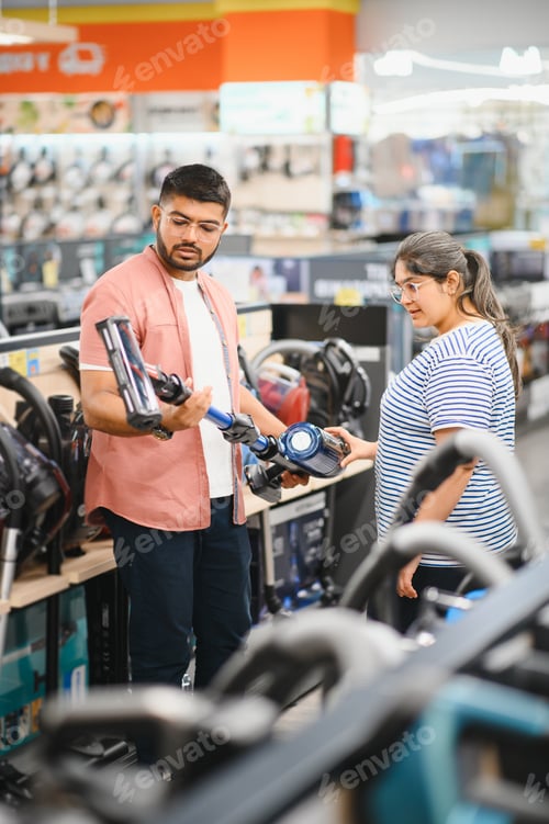 Preview: Indian Couple choosing vacuum cleaner, electronics store