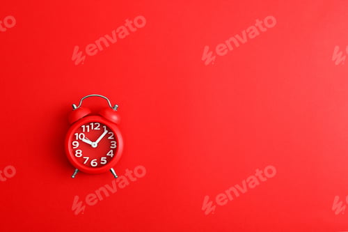 Preview: Modern alarm clock on red background, top view. Space for text