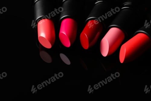 Preview: Many bright lipsticks on black glass surface, space for text