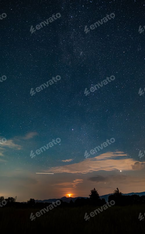 Preview: Starry night sky with glowing sunset over mountains