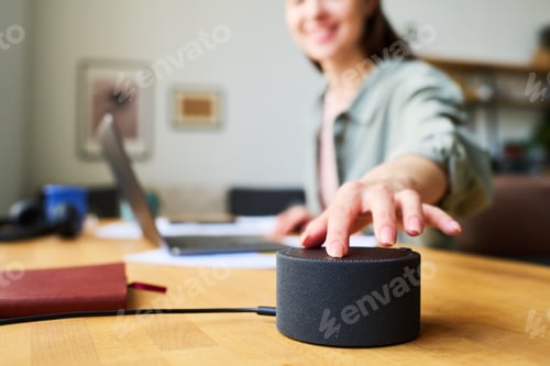 Preview: Woman using smart speaker at home