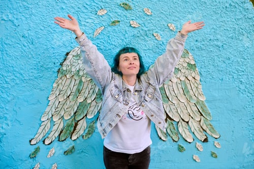 Preview: Woman with angel wings mural on blue wall