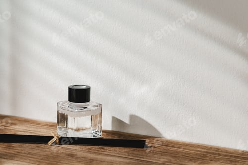 Preview: Elegant Perfume Bottle Bathed in Sunlight on a Wooden Surface