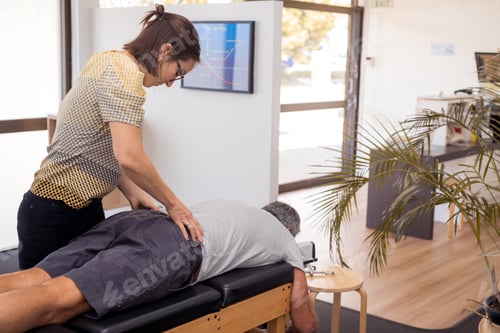 Preview: Senior man having chiropractic adjustment