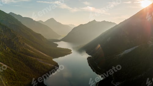 Preview: Breathtaking sunset over the serene waters of Plansee in Austria majestic mountains