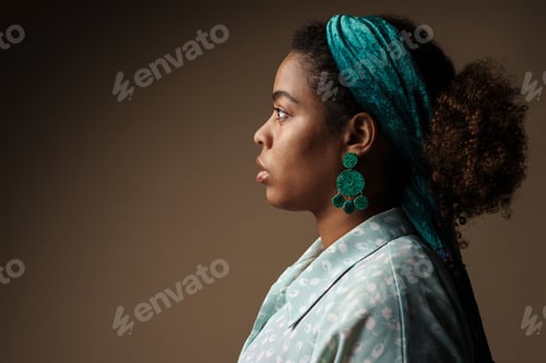 Preview: Young black woman wearing headband posing in profile