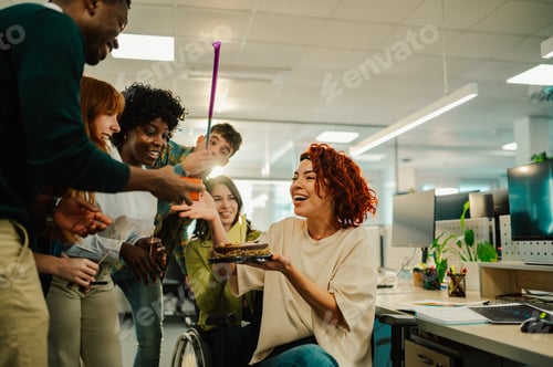 Preview: A happy businesswoman is having birthday surprise party at office.