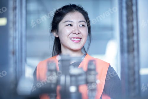 Preview: Happy technician in factory