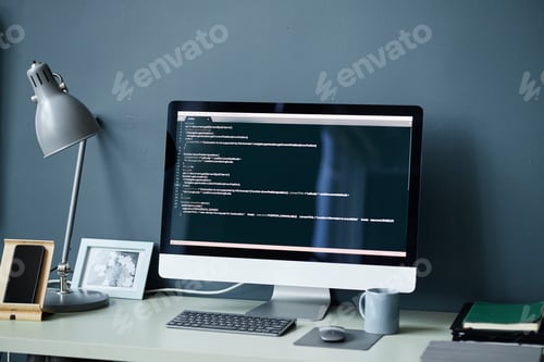 Preview: Modern Desktop Computer Displaying Programming Code in Minimalist Workspace