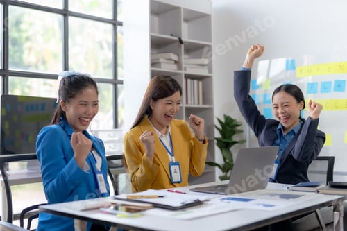 Preview: Team of young Asian business woman using laptop computer in the office, getting good new