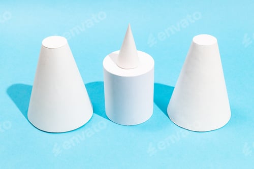 Preview: handmade various paper cones and cylinder on blue