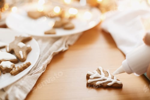 Preview: Decorating baked christmas tree cookie with sugar frosting. Family christmas time