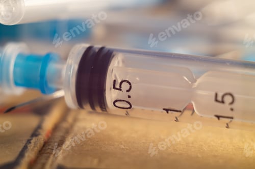 Preview: Closeup shot of syringes on a blurry background