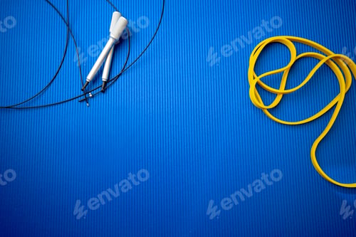 Preview: Jumping rope on blue mat background in a gym