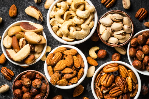 Preview: Assortment of nuts in bowls. Cashew, hazelnuts, pecan, almonds, brazilian nuts and pistachios.