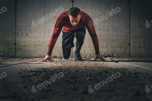 Preview: Athlete in a low start pose, starting a race