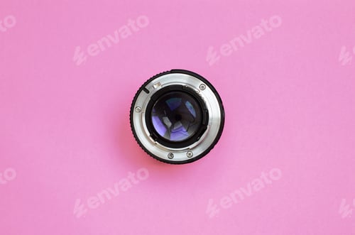 Preview: Camera Lens on a Pink Surface Background