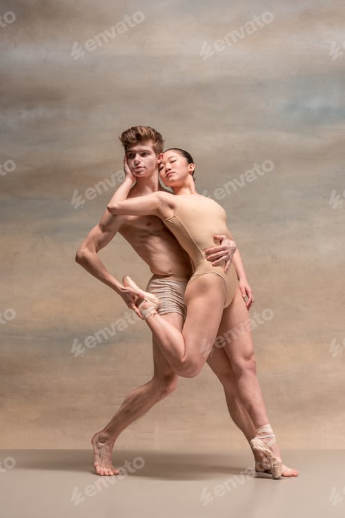 Preview: Couple of ballet dancers posing over gray background