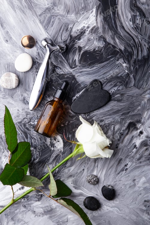 Preview: Minimalist skincare setup with essential massage roller, oil dropper, gua sha