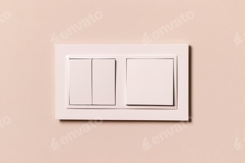 Preview: White electrical switches on beige wall