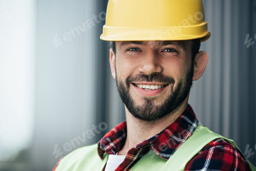 Preview: portrait of male smiling worker in yellow helmet