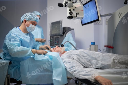 Preview: Senior Man Undergoing Eye Surgery Performed by Young Male Surgeon