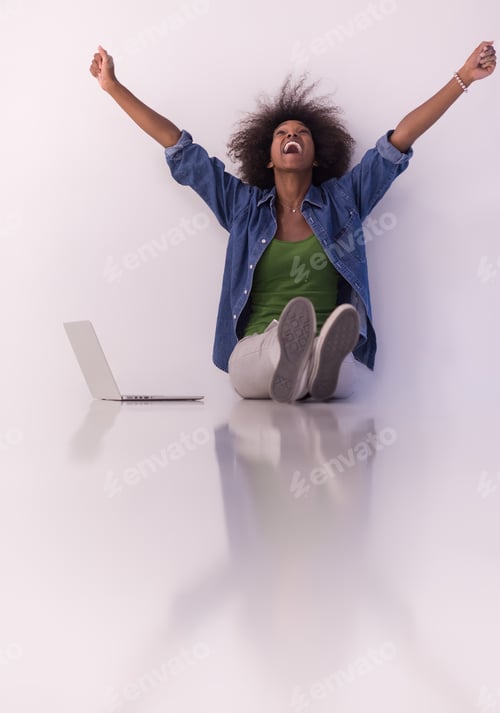 Preview: african american woman sitting on floor with laptop
