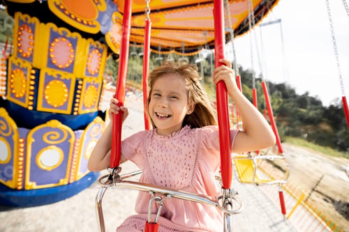 Preview: Kids riding on colorful amusement carousel