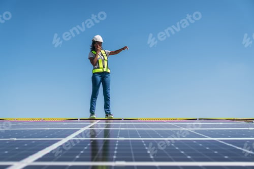 Preview: Service engineer checking solar cell on the roof. Clean energy concept.