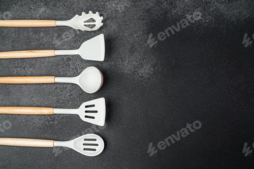 Preview: Various kitchen utensils arranged neatly on a dark surface