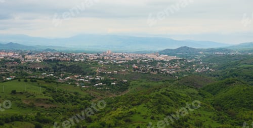 Preview: A panoramic view of Nagorno Karabakh featuring lush green hills and distant mountains