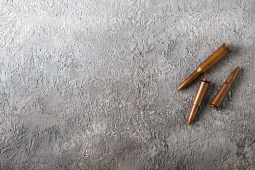 Preview: top view of brown bullets on the white surface tank war death soldier gun